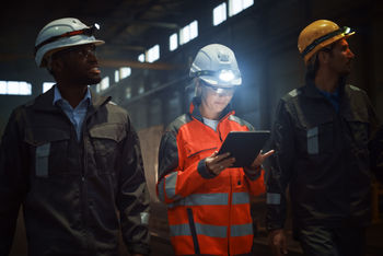 Mining woman looking at clipboard