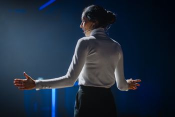 Woman on stage in spotlight