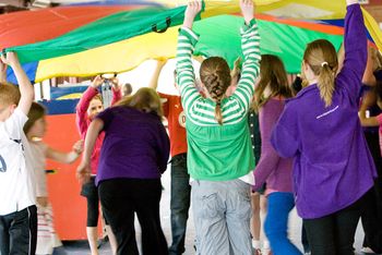 children playing with parachute