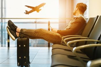 Man relaxing at airport waiting for flight