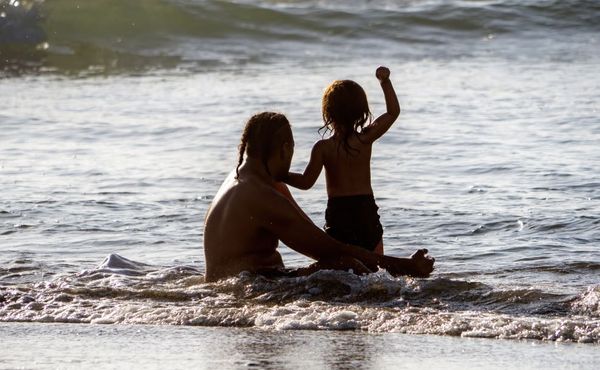 Maori man and child in sea