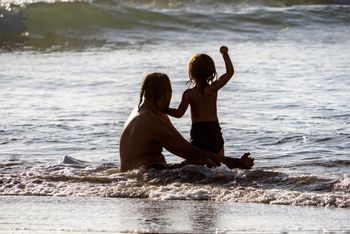 Maori man and child in sea