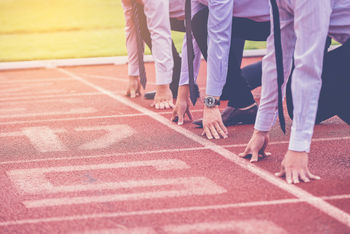 Business people on athletic track start line