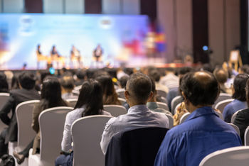 Generic conference hall with back of heads 