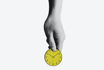 hand holding a yellow clock