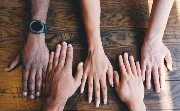 Diverse hands on table 