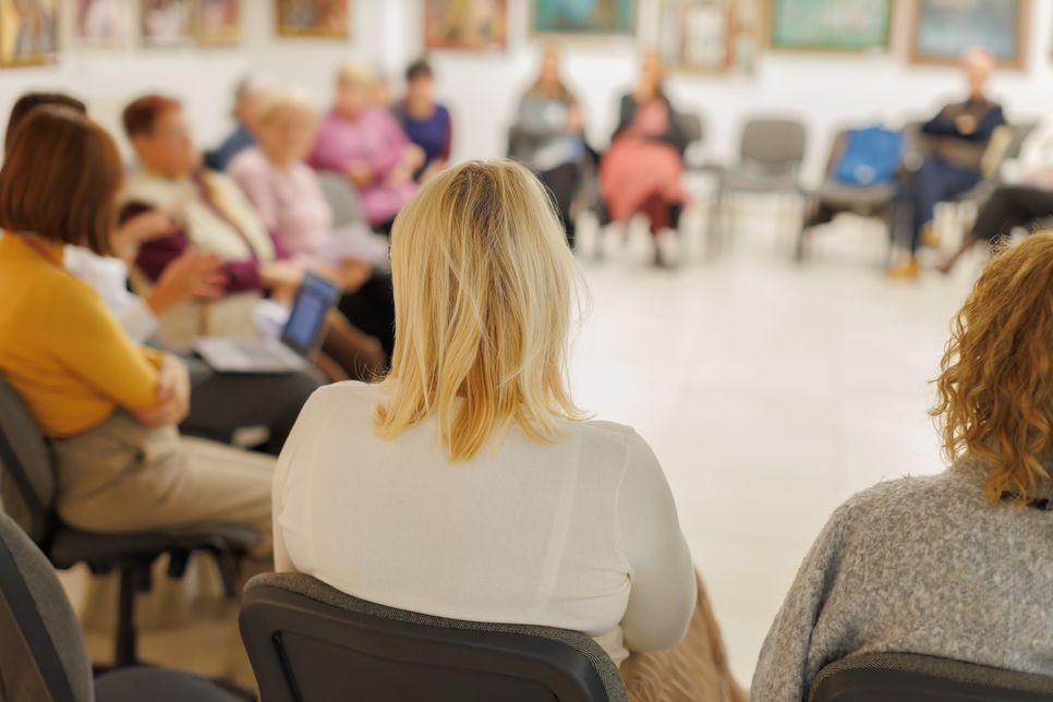 Members engaged in a meeting ...