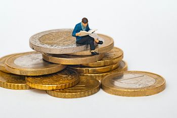 Man sitting on euro coins