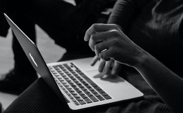 person sitting with laptop