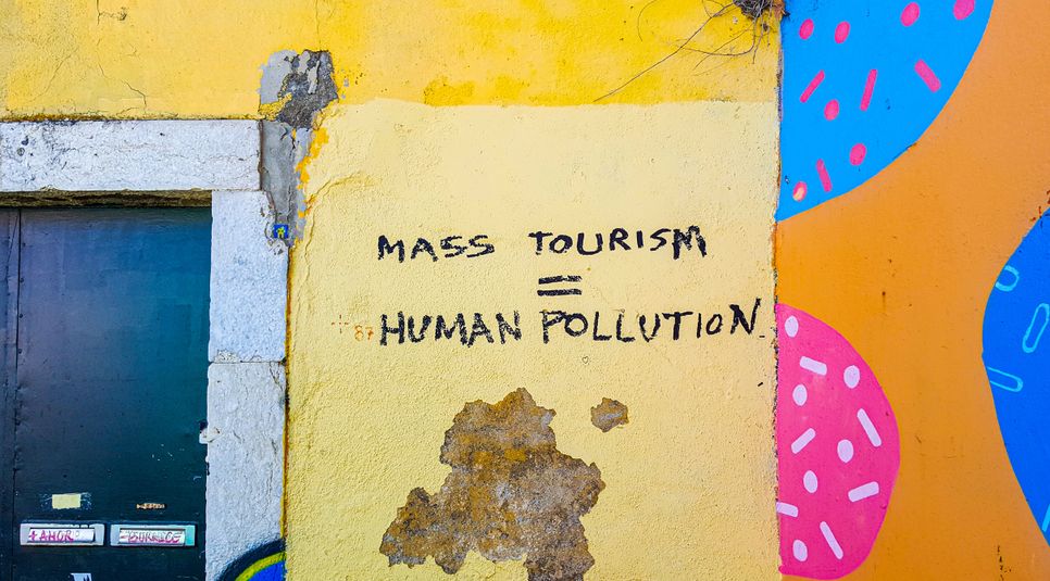 Anti mass tourism slogan on wall