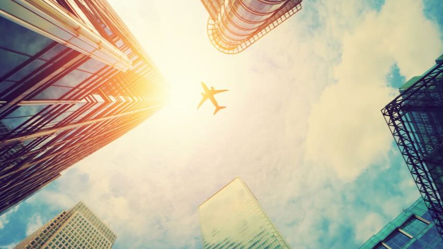 Plane flying above city