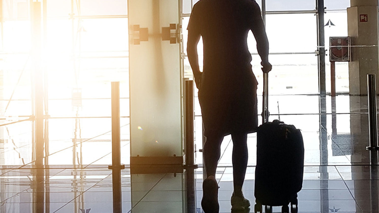 Business traveller at airport with luggage