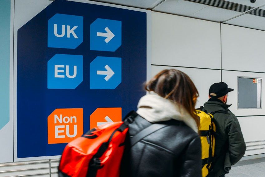 Travellers passing through passport control in the UK