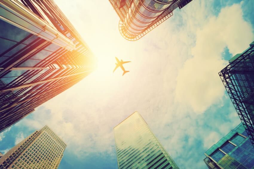 Plane flying above city
