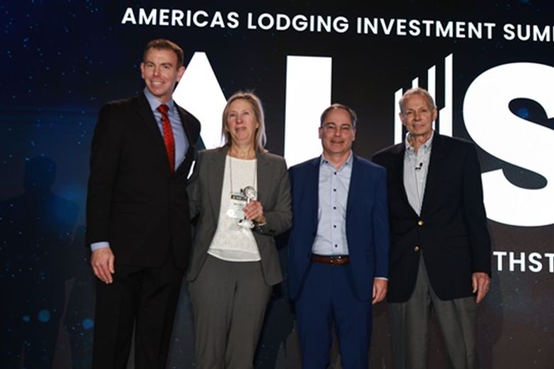 Michelle Russo, HotelAVE, and Ian Gaum, Newbond (center) accept Single Asset Transaction of the Year.