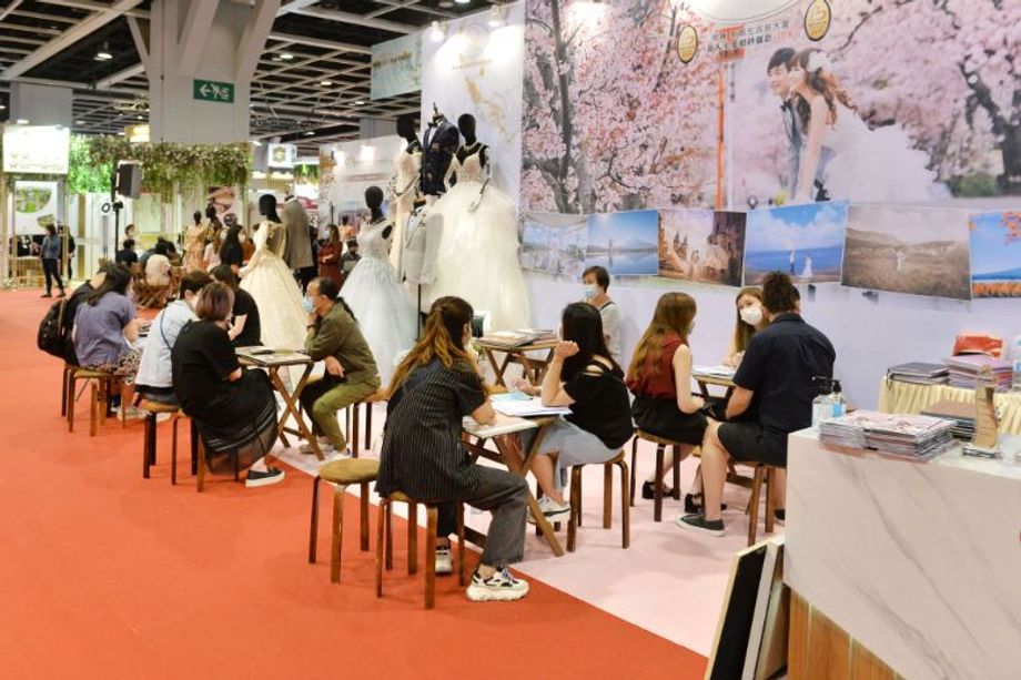 Wedding Fair: all smiles for soon-to-wed couples behind facemasks as they touched wedding gowns on display, tried on wedding rings and reviewed proposals of wedding venues.