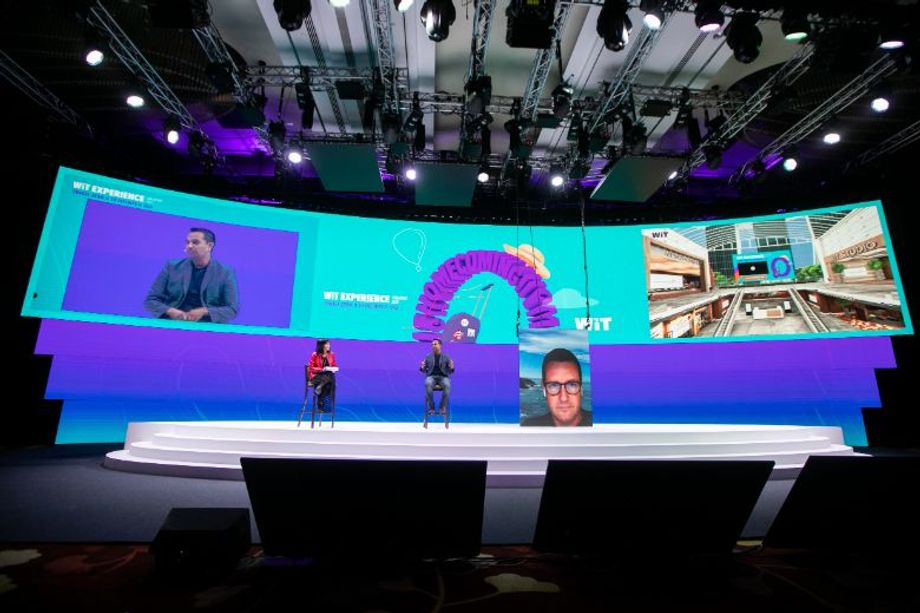 An omnichannel experience at WiT: in-person at MBS, joined by a virtual panelist on the new drop-down LED panel, and attendees on the Virtual Meeting Place digital platform.