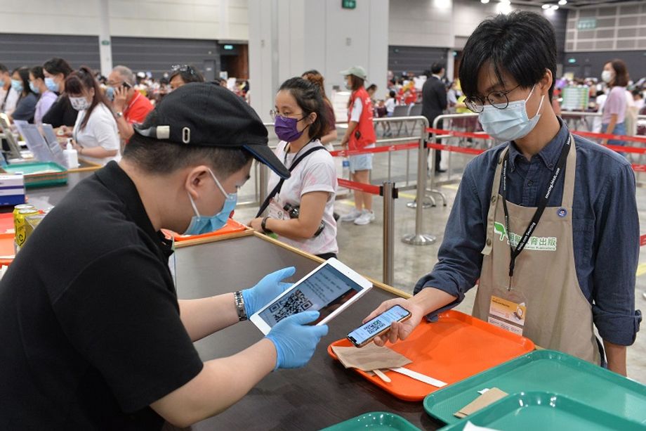 Attendees scanning QR codes to redeem meal boxes at HKCEC.