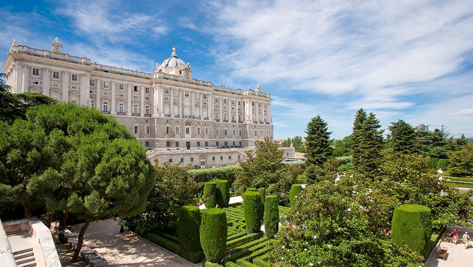 Palacio Real, or the Royal Palace of Madrid, is surrounded by landscaped gardens and trees.
