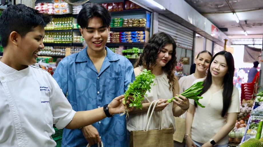 The team-building activity starts with Thai herbs and ingredients picking at a local market.