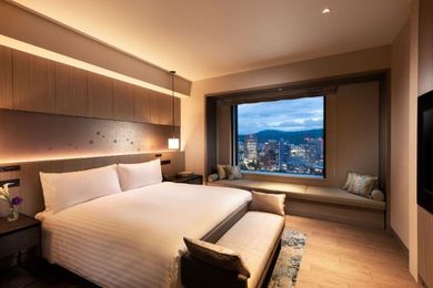 Hilton Hiroshima’s one-bedroom suite offers views of the city with the mountains looming in the distance.