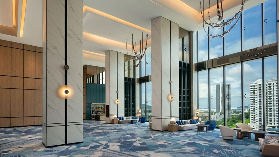 Pre-function area with high ceiling and skyline views.