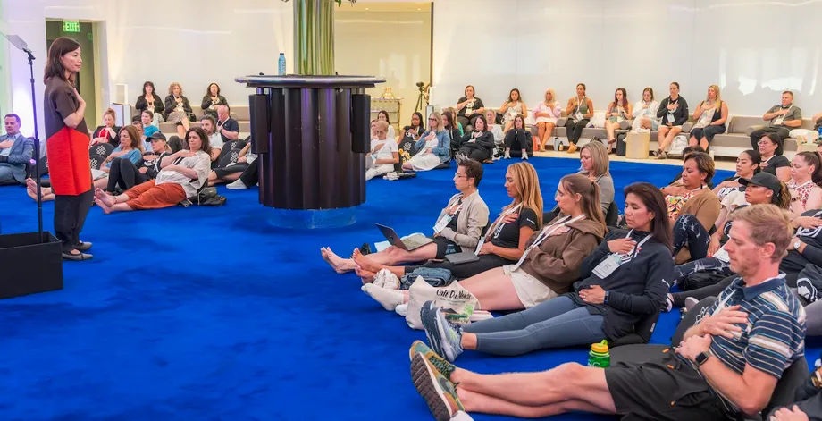 Dami Kim of Body & Brain Wellness leads stress-reduction exercises during Caesars Global Wellness Forum.