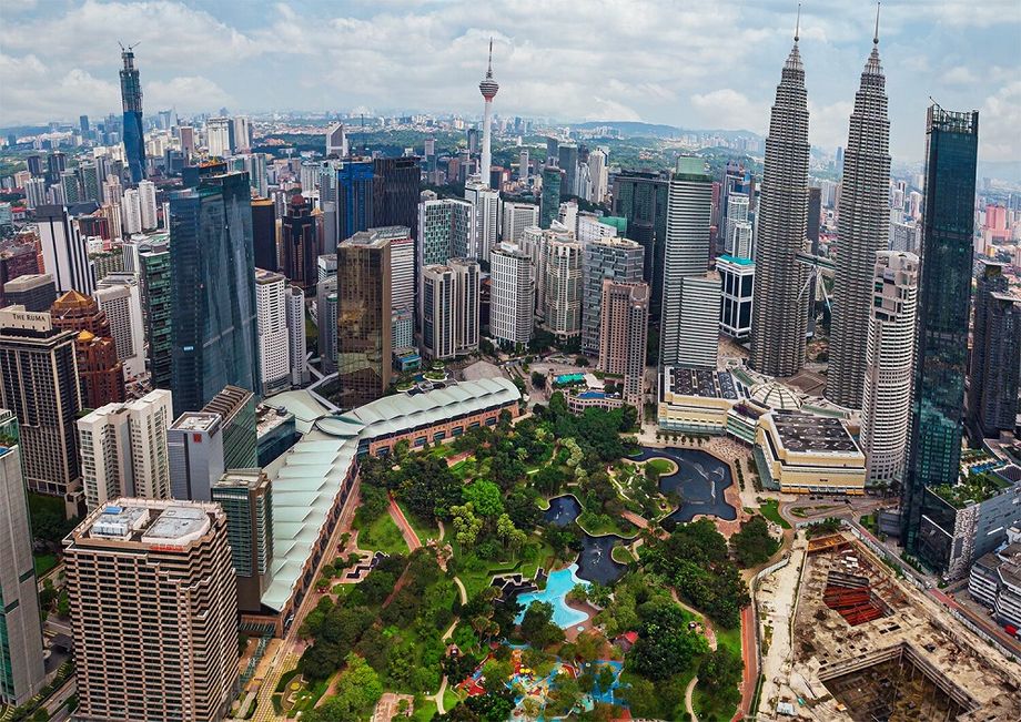 The integrated Kuala Lumpur City Centre precinct where the Kuala Lumpur Convention Centre overlooks the Petronas Twin Towers and the KLCC Park.