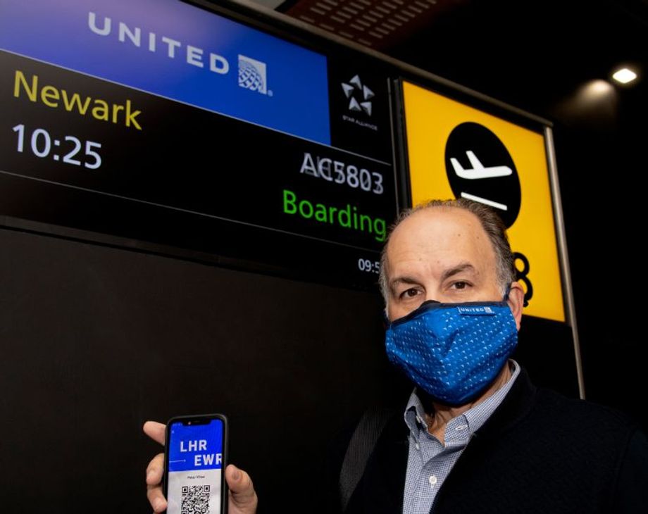 Internova's Peter Vlitas holds up his unique QR code on the CommonPass health pass before boarding his flight from London to Newark.