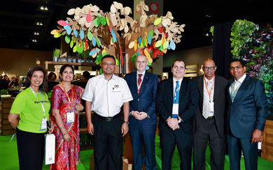 Team MITEC, booth visitors and the Secretary General Datuk Isham Ishak Ministry of International Trade and Industry (3rd from left) stand under the colourful Tree of Hope.