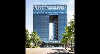 A view of the Novotel Ambassador Seoul Dongdaemun from the street level.