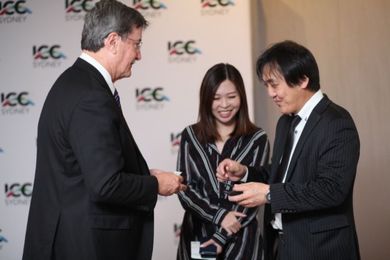 Geoff Donaghy, CEO of ICC Sydney, shares business card with Tokyo guest.