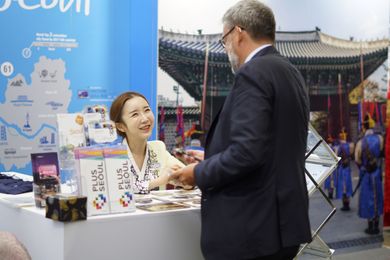 A staff at the Seoul experience booth, where delegates will get to wear traditional Korean costumes and other cultural activities.