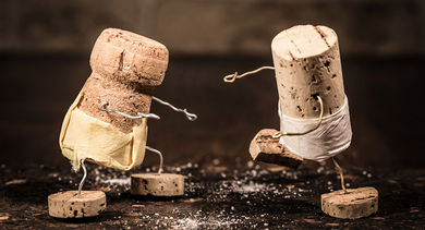 Conceptual photo of wine cork figures engaging in sumo wrestling (Credit: miriam-doerr/iStock)