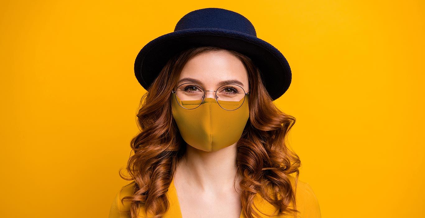 smiling-woman-face-mask-deagreez-adobestock_345665996
