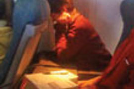 Woman seated near jet window thumbnail