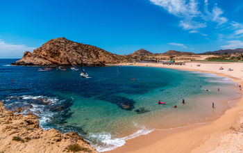 Beautiful Santa Maria beach by Cabo San Lucus has full life guarding and bathroom facilities. It is a sheltered beach that provides safe swimming and snorkeling areas. (photo via rand22 / iStock / Getty Images Plus)