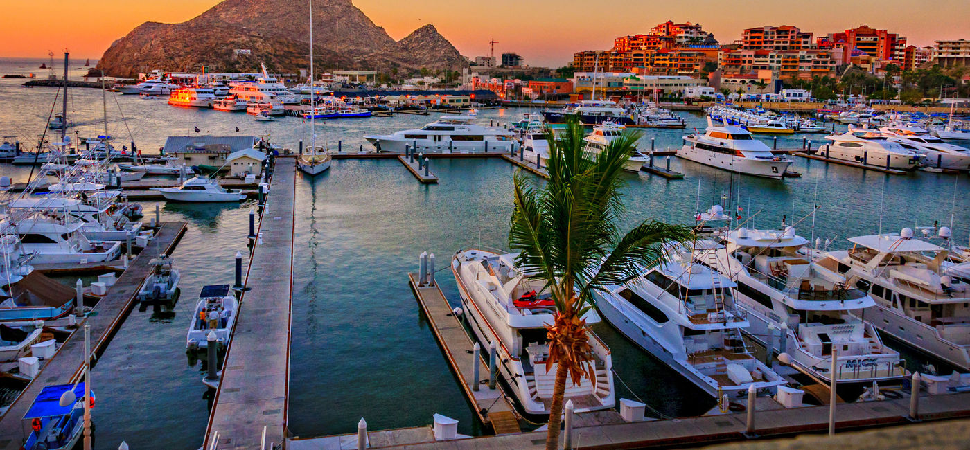 Photo: Cabo San Lucas Marina at sunset. (Photo via LindaYG / iStock / Getty Images Plus)
