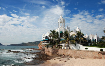 Buildings,Mazatlan, Coastline, water, ocean, pacific, architecture, cafe, bar, restaurants, spanish ,islands, palm trees (photo via Travel_Bug / iStock / Getty Images Plus)