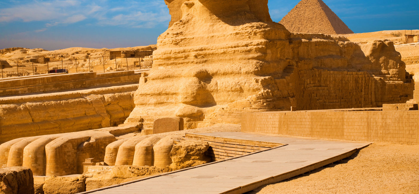 Image: PHOTO: Full length body profile of Great Sphinx including head, feet with great pyramid of Menkaure in background on a clear, blue sky day in Giza, Egypt empty with no people. (photo via pius99 / iStock / Getty Images Plus)