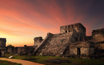 Castillo fortress at sunset in the ancient Mayan city of Tulum, Mexico (photo via Soft_Light / iStock / Getty Images Plus)