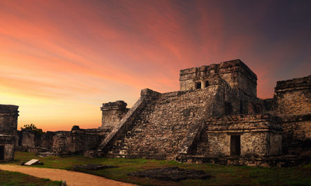 Castillo fortress at sunset in the ancient Mayan city of Tulum, Mexico (photo via Soft_Light / iStock / Getty Images Plus)