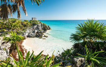 Tulum mayan ruins on the sea in yucatan mexico (photo via tommasolizzul / iStock / Getty Images Plus)