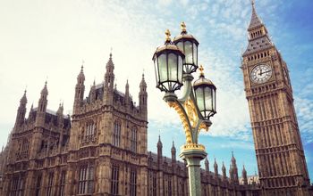 Big Ben in London with the houses of parliament and ornate street lamp (photo via BrianAJackson / iStock / Getty Images Plus)