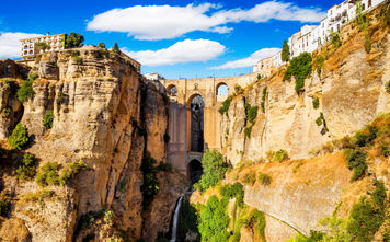 Panoramic view of the old city of Ronda, one of the famous white villages in the province of Malaga, Andalusia, Spain (photo via MarquesPhotography / iStock / Getty Images Plus)