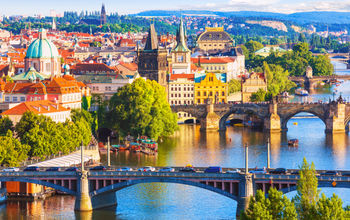Scenic summer aerial view of the Old Town pier architecture and Charles Bridge over Vltava river in Prague, Czech Republic (Photo via scanrai / iStock / Getty Images Plus)