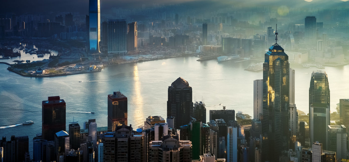 Image: Hong Kong City and Harbor at Sunrise.  (photo via EarnestTse/iStock/Getty Images Plus)