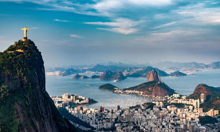 Aerial view of Rio De Janeiro. Corcovado mountain with statue of Christ the Redeemer, urban areas of Botafogo, Flamengo and Centro, Sugarloaf mountain. (photo via microgen / iStock / Getty Images Plus)