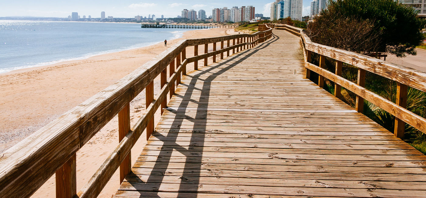 Image: Deck at the beach in the seaside of Punta del Este (photo via brupsilva / iStock / Getty Images Plus)