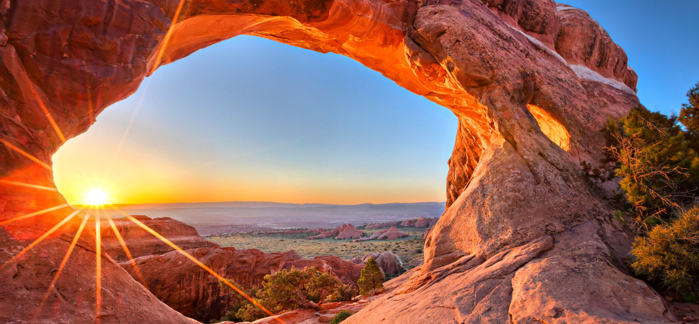Image: Sunrise at Partition Arch in Utah Arches National Park (Photo via tonda / iStock / Getty Images Plus)